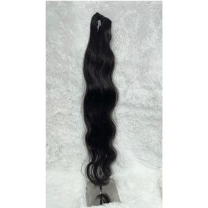Vietnamese Long black wavy hair extension displayed on a white fluffy background.